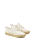 White leather sneakers on a beige sole  AJAKS