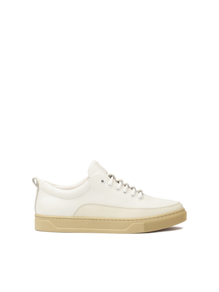 White leather sneakers on a beige sole  AJAKS