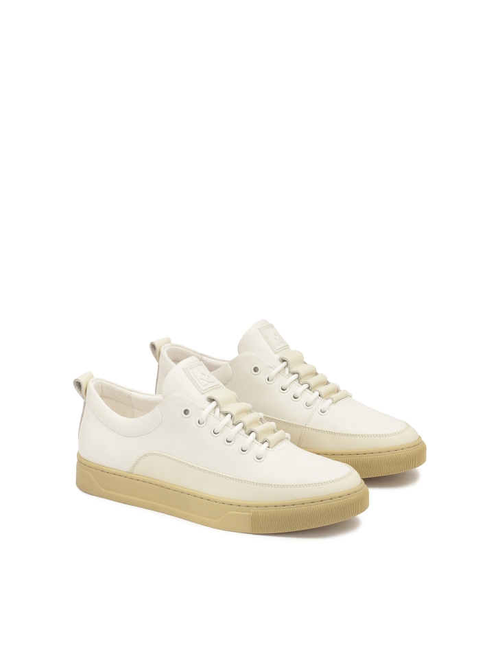 White leather sneakers on a beige sole  AJAKS